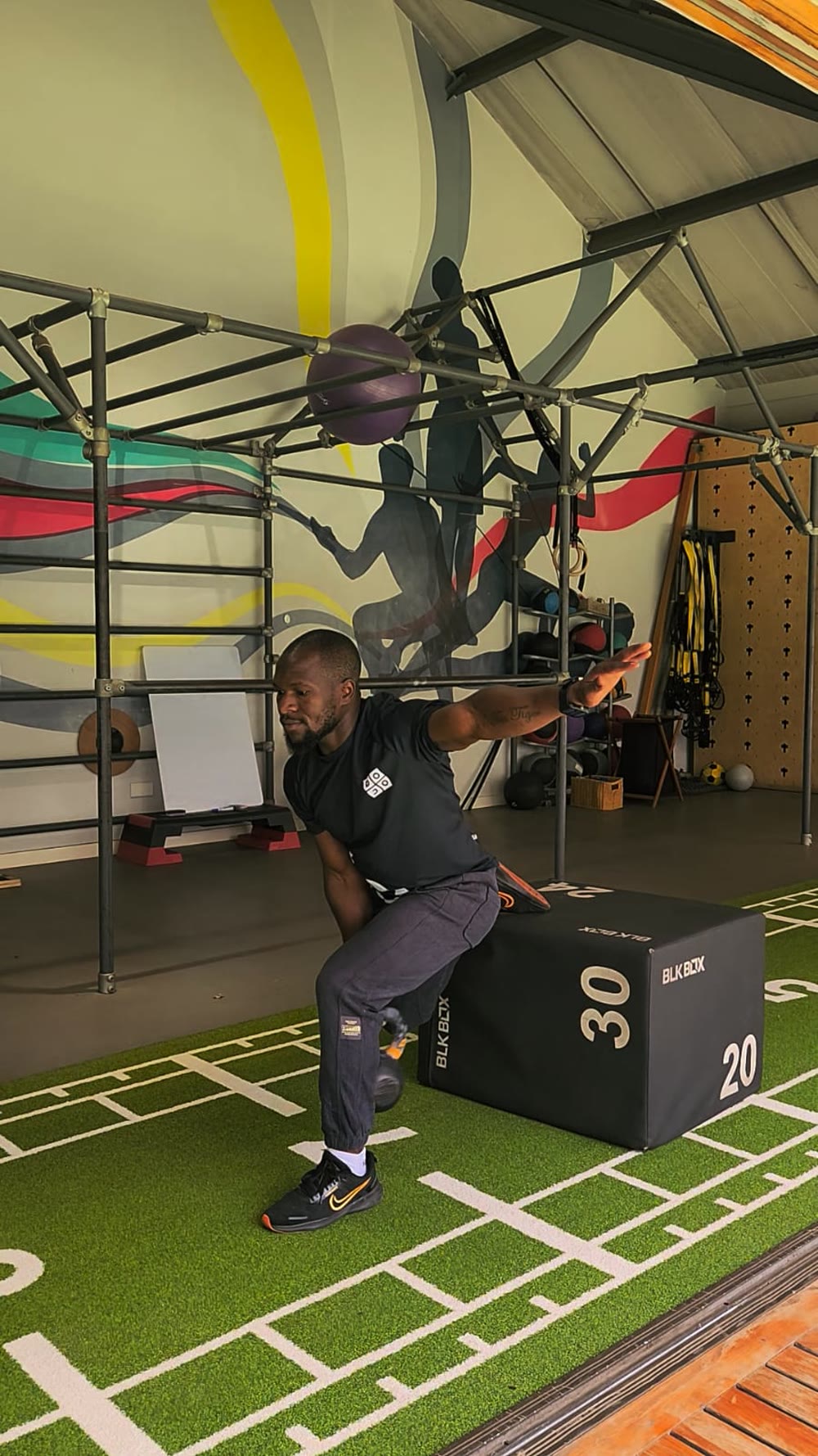 Tim in a one-leg kettlebell swing, arm out for balance